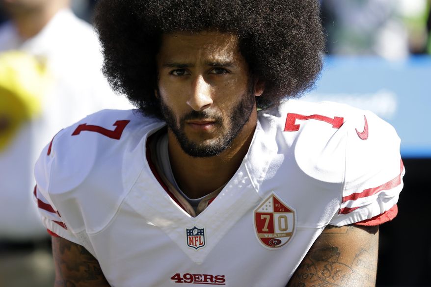 In this Sept. 25, 2016, file photo, San Francisco 49ers quarterback Colin Kaepernick kneels during the national anthem before an NFL football game against the Seattle Seahawks in Seattle. Kaepernick was a second-round draft pick in 2011 who the next year led the San Francisco 49ers to the Super Bowl. By 2016, he had begun kneeling on the sideline at games during the national anthem to protest social injustice and police brutality.  Soon after, he was gone from the NFL, and he has not played since. (AP Photo/Ted S. Warren) ** FILE **