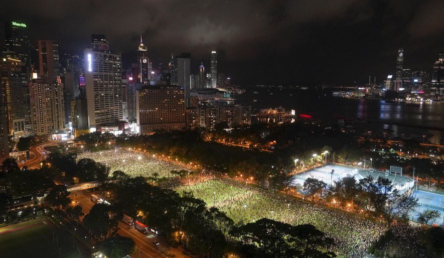 People gather for a vigil for the victims of the 1989 Tiananmen Square Massacre at Victoria Park in Causeway Bay, Hong Kong, Thursday, June 4, 2020, despite applications for it being officially denied. China is tightening controls over dissidents while pro-democracy activists in Hong Kong and elsewhere try to mark the 31st anniversary of the crushing of the pro-democracy movement in Beijing&#39;s Tiananmen Square. (AP Photo/Vincent Yu)