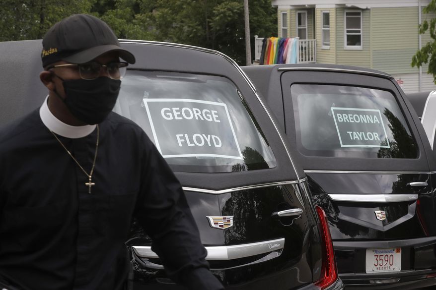Rev. James Harrison, of the Southern Baptist Church, in Boston, walks Sunday, June 7, 2020 walks past hearses meant to honor fallen George Floyd, Breonna Taylor, and Ahmaud Arbery, before the start of a procession through Boston. The procession and a number of protests were triggered by the death of George Floyd who died on May 25 as a Minneapolis police officer pressed his knee into his neck, ignoring his cries and bystander shouts until he eventually stopped moving. (AP Photo/Steven Senne)