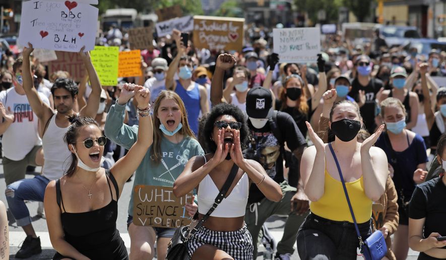 Protesters march through the streets of Manhattan, New York, Sunday, June 7, 2020. New York City lifted the curfew spurred by protests against police brutality ahead of schedule Sunday after a peaceful night, free of the clashes or ransacking of stores that rocked the city days earlier. (AP Photo/Seth Wenig)