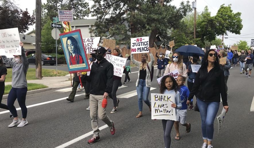 Demonstrators march Saturday, June 6, 2020, in Bend, Ore., to protest racism and police brutality. (AP Photo/Andrew Selsky) ** FILE **