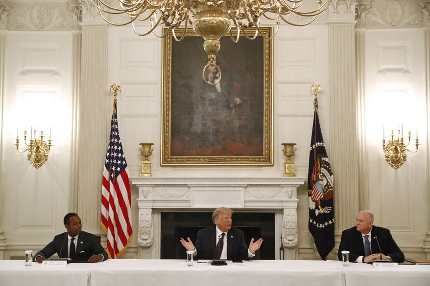 President Donald Trump speaks during a roundtable discussion with law enforcement officials, Monday, June 8, 2020, at the White House in Washington. Seated with Trump are Kentucky Attorney General Daniel Cameron, left, and Pat Yoes, National President of the Fraternal Order of Police. (AP Photo/Patrick Semansky)