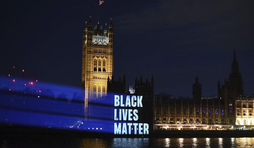 Black Lives Matter is projected onto the Houses of Parliament, in London, Friday, June 5, 2020, as part of the ongoing worldwide demonstrations following the death of George Floyd. Just like the coronavirus, racism has no borders. Across the world, disgruntled people, representing a broad spectrum of society, marched this weekend as one to protest against racial injustices at home and abroad. (Victoria Jones/PA via AP)