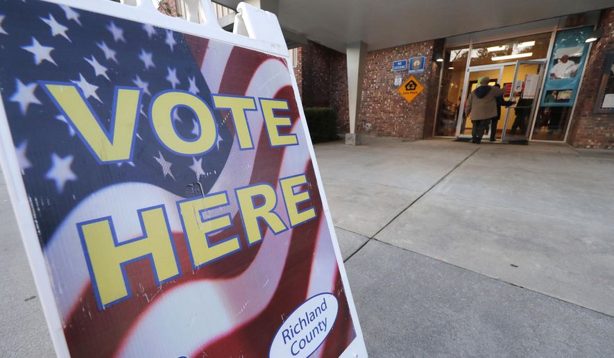 People people enter a polling station to vote as the polls open in the morning, in the Greenview section of Columbia, S.C., Saturday, Feb. 29, 2020. (AP Photo/Gerald Herbert)