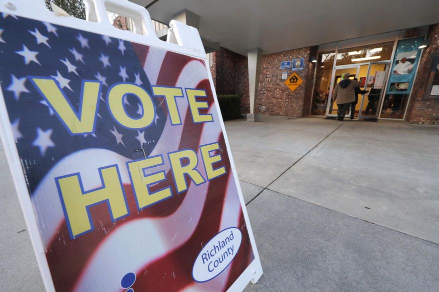 People people enter a polling station to vote as the polls open in the morning, in the Greenview section of Columbia, S.C., Saturday, Feb. 29, 2020. (AP Photo/Gerald Herbert)