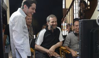 In this image released by Universal Pictures, Pete Davidson, left, appears with director Judd Apatow, center, during the filming of &amp;quot;The King of Staten Island.&amp;quot; (Mary Cybulski/Universal Pictures via AP)