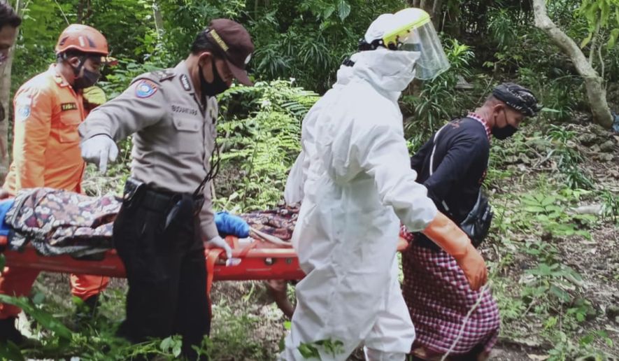 In this photo released by Indonesian National Search And Rescue Agency (BASARNAS), rescuers carry Ukrainian man Roberts Jacob Matthews on stretcher in Pecatu, Bali, Indonesia, on June 6, 2020. Matthews, who fell into an abandoned well and broke his leg while being chased by a wild dog on Indonesia’s tourist island of Bali, was rescued after being trapped for nearly a week, police said Monday, June 8, 2020. (BASARNAS via AP)