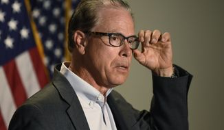 Sen. Mike Braun, R-Ind., speaks to reporters as he arrives for the weekly Republican policy luncheon on Capitol Hill in Washington, Tuesday, June 9, 2020. (AP Photo/Susan Walsh)