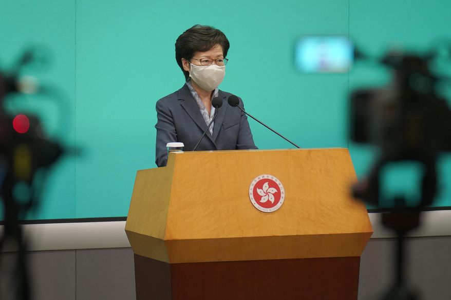 Hong Kong Chief Executive Carrie Lam listens to reporters questions during a press conference in Hong Kong, Tuesday, June 9, 2020. Lam said everyone should learn a lesson from last year's giant anti-government protests. But she did not say what lesson she has learned. Instead, she urged everyone to support the new national security legislation that the central government in Beijing is going to impose on Hong Kong. (AP Photo/Vincent Yu)