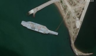 In this Sunday, June 7, 2020 satellite photo provided by Maxar Technologies, a fake aircraft carrier is seen off the coast of Bandar Abbas, Iran. As tensions remain high between Iran and the U.S., the Islamic Republic appears to have constructed a new mockup of an aircraft carrier off its southern coast for potential live-fire drills. The faux foe, seen in satellite photographs obtained by The Associated Press, resembles the Nimitz-class carriers that the U.S. Navy routinely sails into the Persian Gulf from the Strait of Hormuz, its narrow mouth that sees 20% of all the world&#39;s oil pass through it. (Satellite image ©2020 Maxar Technologies via AP)