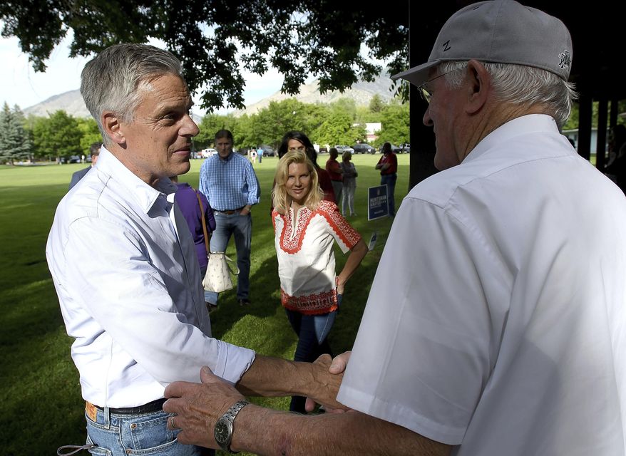 Utah gubernatorial candidate Jon Huntsman Jr., left, shakes hands with people during a campaign stop Thursday, June 4, 2020, in Logan, Utah. (Eli Lucero/Herald Journal via AP)