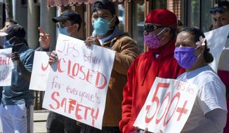 JBS workers protest Tuesday, June 9, 2020, in Logan, Utah. Hundreds of workers at the meatpacking plant in Hyrum, Utah have tested positive for COVID-19. (Eli Lucero/The Herald Journal via AP)