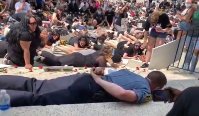 Police Chief Michael D. Shaw of Webster, Massachusetts, defended himself Monday after a Telegram &amp; Gazette video showing him lying on the ground in solidarity with George Floyd protesters went viral. (screengrab via Twitter/@agreenphotog)