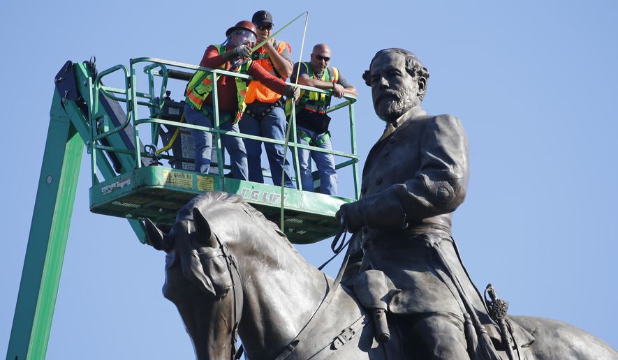 An inspection crew from the Virginia Department of General Services takes measurements as they inspect the statue of Confederate Gen. Robert E. Lee on Monument Avenue Monday, June 8, 2020, in Richmond, Va. Virginia Gov. Ralph Northam has ordered the removal of the statue. (AP Photo/Steve Helber)