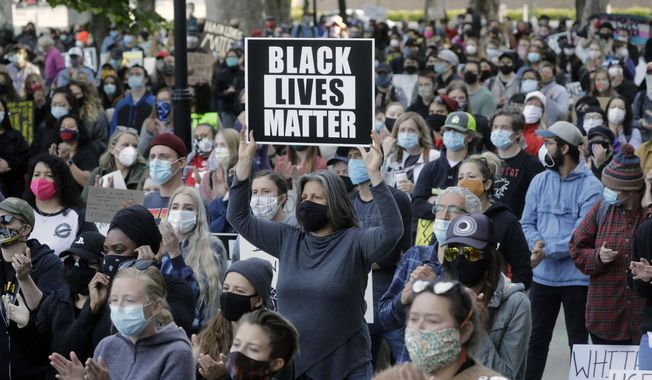 People gather during a Black Lives Matter protest Wednesday, June 10, 2020, in Salt Lake City. With loud chants of "No justice, no peace" and "Black lives matter," a couple of thousand people rallied in downtown Salt Lake City Wednesday morning calling for an end to police brutality. (AP Photo/Rick Bowmer)