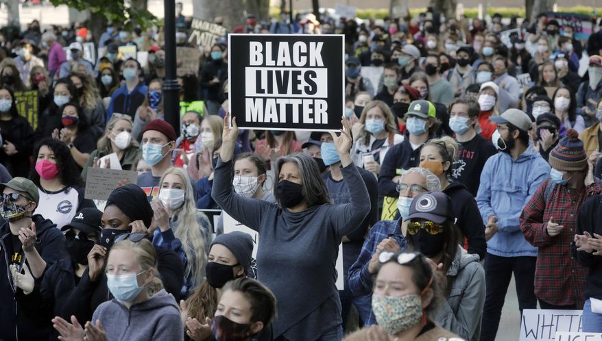 People gather during a Black Lives Matter protest Wednesday, June 10, 2020, in Salt Lake City. With loud chants of "No justice, no peace" and "Black lives matter," a couple of thousand people rallied in downtown Salt Lake City Wednesday morning calling for an end to police brutality. (AP Photo/Rick Bowmer)