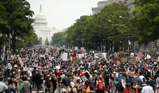 In this June 6, 2020, file photo, demonstrators walk on Pennsylvania Avenue as they protest over the death of George Floyd, a black man who died after being restrained by Minneapolis police officers. A democratic government that is amenable to the changes may enact legislation, or a change of leadership can be forced at the ballot box. (AP Photo/Andrew Harnik, File)