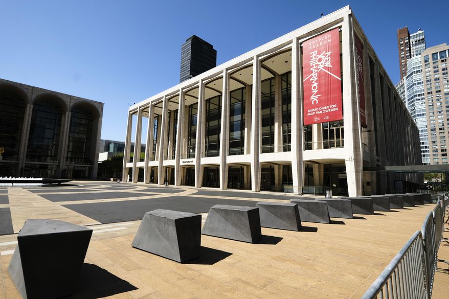 This May 12, 2020 file photo shows David Geffen Hall at Lincoln Center, closed during COVID-19 lockdown, in New York. The New York Philharmonic canceled its fall season because of the coronavirus pandemic and has moved up the start of Geffen Hall’s reconstruction to take advantage of the orchestra’s absence. Philharmonic President Deborah Borda said Wednesday she hopes to resume performances on Jan. 6. (Photo by Evan Agostini/Invision/AP, File) **FILE**