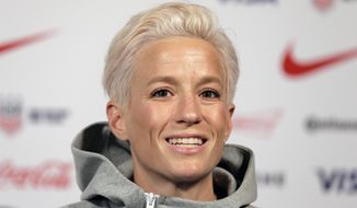 FILE - In this May 24, 2019, file photo, Megan Rapinoe, a member of the United States women&#39;s national soccer team, speaks to reporters during a news conference in New York. Groups that advocate for civil rights and women’s rights have joined notable athletes in asking the NCAA to move the first and second rounds of the 2021 men’s basketball tournament out of Idaho after the state passed a law banning transgender women from competing in women’s sports. A letter sent and signed by a list of professional athletes including Megan Rapinoe, Billie Jean King, Jason Collins and Sue Bird calls for the NCAA to move the games set to be held March 2021 at Boise State University. (AP Photo/Seth Wenig, File)