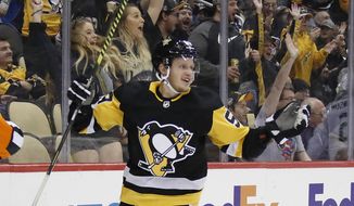 FILE - In this Oct. 16, 2019, file photo, Pittsburgh Penguins&#39; Jake Guentzel celebrates after scoring during the second period of an NHL hockey game against the Colorado Avalanche in Pittsburgh. Guentzel feared his season was over thanks to a shoulder injury in December. The &amp;quot;pause&amp;quot; caused by the pandemic has given him renewed optimism that he will be ready when the playoffs hopefully being this summer. (AP Photo/Gene J. Puskar, File)