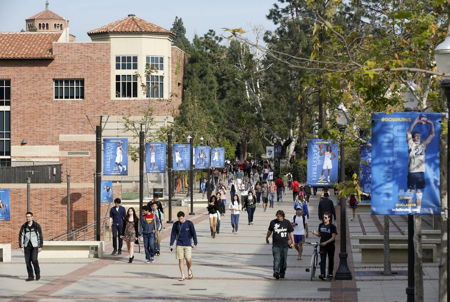 In this Feb. 26, 2015, file photo, students walk on the University of California, Los Angeles campus. A UCLA professor who was suspended following an email exchange with a student who wanted a final exam altered or canceled because of racial unrest, says his refusal to do so has nothing to do with racism. (AP Photo/Damian Dovarganes, File)