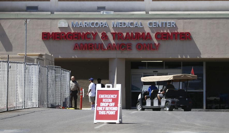 The emergency room entrance at Valleywise Health Center hospital is shown Wednesday, June 10, 2020, in Phoenix, as Arizona hospitals that are expected to be able to treat new cases of coronavirus without going into crisis mode were above 80% capacity Tuesday, a milestone that should trigger an automatic stop to elective surgeries at affected hospitals. The state is dealing with a surge in virus cases and hospitalizations that experts say is likely tied to Gov. Doug Ducey's ending of statewide closure orders in mid-May. (AP Photo/Ross D. Franklin)