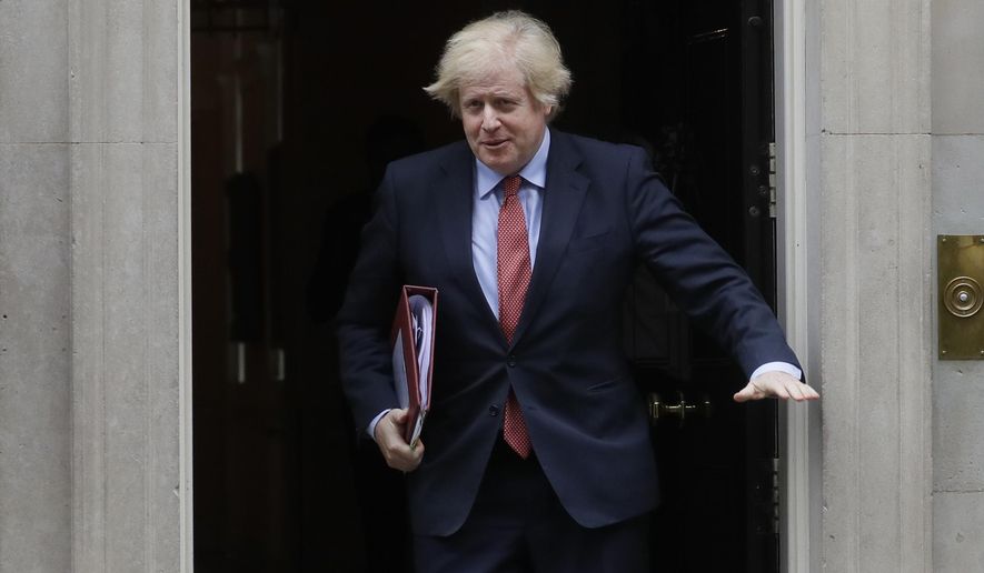 Britain's Prime Minister Boris Johnson leaves 10 Downing Street to attend the weekly session of PMQs in Parliament in London, Wednesday, June 10, 2020. (AP Photo/Kirsty Wigglesworth)