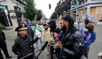 Hip-hop artist and activist Raz Simone (right) has emerged as a leading figure of Black Lives Matter in the self-declared &quot;Capitol Hll Autonomous Zone&quot; in Seattle. (Associated Press)