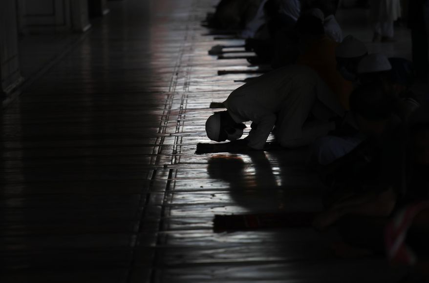 Indian Muslims offer prayers after Jama Mosque opened after lockdown in New Delhi, India, Monday, June 8, 2020. India is reopening its restaurants, shopping malls and religious places in most of its states after a more than 2-month-old lockdown even as the country continues to witness a worrying rise in new coronavirus infections. (AP Photo/Manish Swarup)