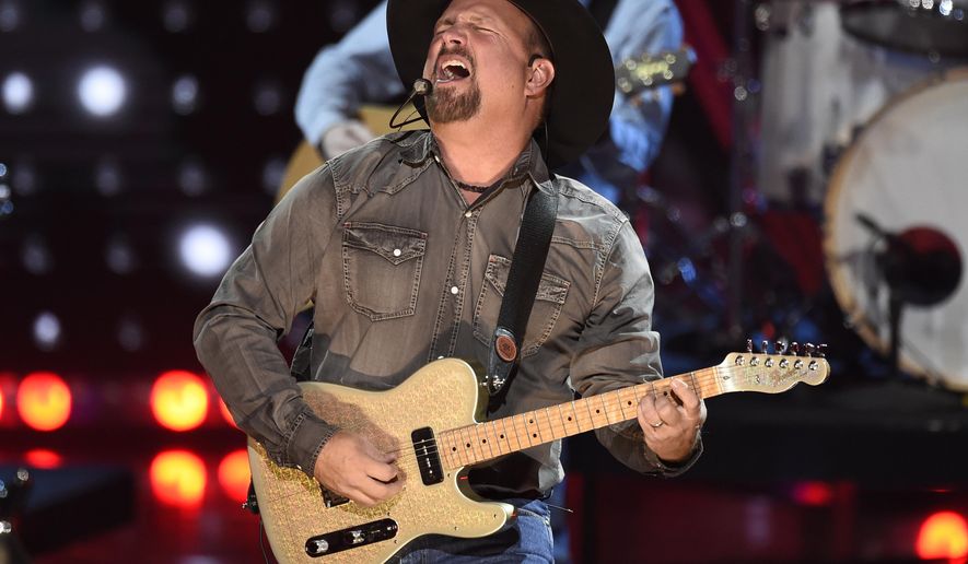FILE - This March 14, 2019 file photo shows Garth Brooks performing at the iHeartRadio Music Awards in Los Angeles. Brooks is holding a concert in Nashville,Tenn., that will be played at 300 drive-in theaters across the country. Tickets will cost $100 per passenger car or truck. (Photo by Chris Pizzello/Invision/AP, File)