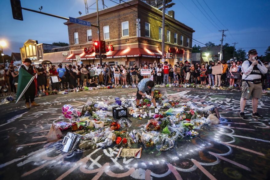 FILE - In this Monday, June 1, 2020, file photo, protesters gather at a memorial for George Floyd where he died outside Cup Foods on East 38th Street and Chicago Avenue, in Minneapolis. Floyd was killed May 25 after employees at a store owned by a Palestinian American Muslim called police over a suspected counterfeit bill. The store’s role in Floyd’s death has reignited debates among Muslims over the responsibilities of immigrant Muslims who own businesses in black neighborhoods, from caution in calling police to helping end food deserts. (AP Photo/John Minchillo, File)