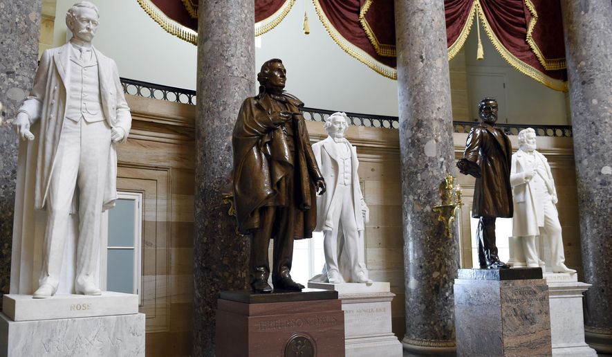 In this June 24, 2015, file photo, a statue of Jefferson Davis, second from left, president of the Confederate States from 1861 to 1865, is on display in Statuary Hall on Capitol Hill in Washington. House Speaker Nancy Pelosi is demanding that statues of Confederate figures such as Jefferson Davis be removed from the U.S. Capitol. (AP Photo/Susan Walsh, File)
