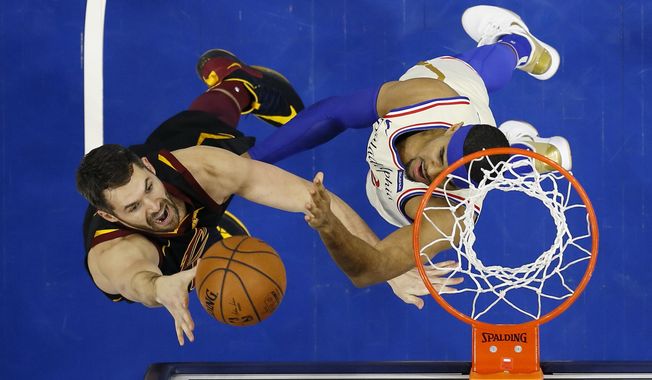 FILE - In this Dec. 7, 2019, file photo, Cleveland Cavaliers&#x27; Kevin Love, left, goes up to shoot against Philadelphia 76ers&#x27; Tobias Harris during the first half of an NBA basketball game, Saturday, Dec. 7, 2019, in Philadelphia. The NBA&#x27;s decision to only invite 22 teams to resume play at Disney World in Florida next month was a body blow for players on the omitted squads _ aka the Delete 8. And although they have had time to process the exclusion, Sexton, Cavs star forward Love and their teammates, are still struggling with the reality that their season is over. (AP Photo/Matt Slocum, File)