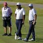 From right, Zac Blair, Harold Varner III and caddie Rick Wynn observe a moment of silence to pay their respects to the memory of George Floyd on the 16th hole during the second round of the Charles Schwab Challenge golf tournament at the Colonial Country Club in Fort Worth, Texas, Friday, June 12, 2020. (AP Photo/David J. Phillip)