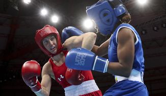 FILE - In this Aug. 2, 2019, file photo, Ingrit Valencia, right, of Colombia and Virginia Fuchs, of the United States compete in the women&#39;s flyweight boxing final bout at the Pan American Games in Lima, Peru. U.S. Olympic team boxer Fuchs will face no punishment for failing a doping test after the U.S. Anti-Doping Association determined the violation had been caused by two substances transmitted by her boyfriend through sex. USADA announced its ruling Thursday, June 11, 2020, clearing the 32-year-old Fuchs, who intends to qualify for the Tokyo Olympics next year as a flyweight. (AP Photo/Martin Mejia, File)