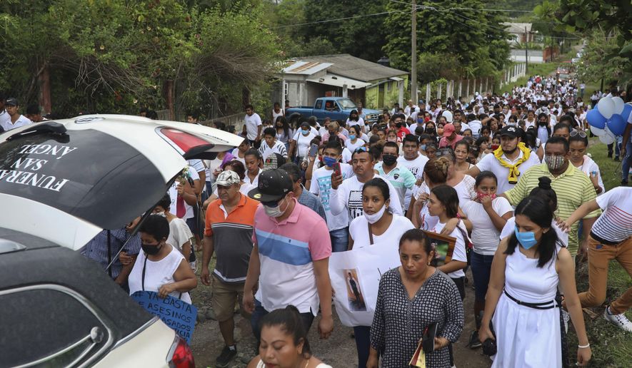 The hearse carrying the remains of Alexander Martinez is followed by a multitude of family and friends during his funeral in Acatlan de Perez Figueroa, Mexico, Thursday, June 11, 2020. Hundreds of residents of this town in southern Mexico bid farewell amid anger and tears to Alexander Martinez, a 16-year-old Mexican-American boy shot dead by local police. (AP Photo/Felix Marquez)