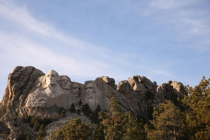 This Dec. 8, 2019, photo shows shows Mount Rushmore in Keystone, S.D. Organizers have scrapped plans to mandate social distancing during President Donald Trump's appearance at a July 3, 2020, Mount Rushmore fireworks display and won't limit the crowd due to coronavirus concerns, South Dakota Gov. Kristi Noem said Thursday, June 4, 2020. The Republican governor said the National Park Service is dolling out 7,500 tickets via lottery for the event, which marks the first time in a decade that fireworks will be set off at the memorial in recognition of Independence Day. (AP Photo/Stephen Groves)