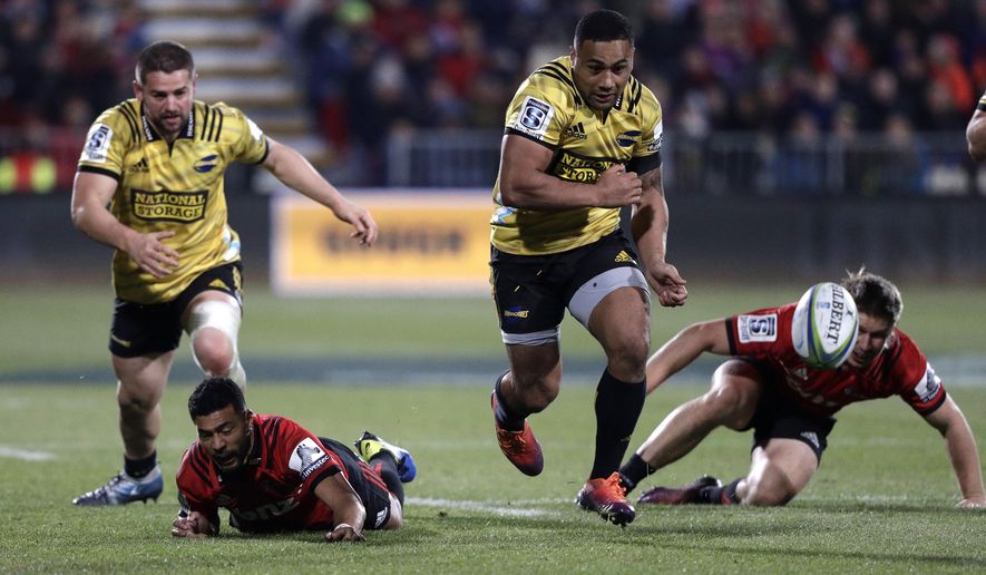 FILE - In this June 29, 2019, file photo, Hurricanes Ngani Laumape kicks the ball down field during the Super Rugby semifinal between the Crusaders and the Hurricanes in Christchurch, New Zealand. The cheers of the crowd will resound in New Zealand sports stadiums for the first time in months with more than 50,000 people expected to attend matches in the opening round of Super Rugby Aotearoa. More than 18,000 are expected at the first match in the New Zealand professional rugby tournament in Dunedin on Saturday, June 13, 2020 between the Highlanders and the Hamilton-based Chiefs. (AP Photo/Mark Baker,File)