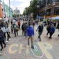 Visitors walk near a sign that reads "Welcome to CHOP," Sunday, June 14, 2020, inside what has been named the Capitol Hill Occupied Protest zone in Seattle. Protesters calling for police reform and other demands have taken over several blocks near downtown Seattle after officers withdrew from a police station in the area following violent confrontations. The CHOP name is a change from CHAZ (Capitol Hill Autonomous Zone) that was used earlier in the week. (AP Photo/Ted S. Warren) **FILE**