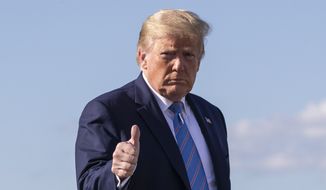 President Donald Trump gives a thumbs-up while walking across the tarmac as he boards Air Force One at Morristown Municipal Airport, Sunday, June 14, 2020, in Morristown, N.J. Trump is returning to Washington. (AP Photo/Alex Brandon)