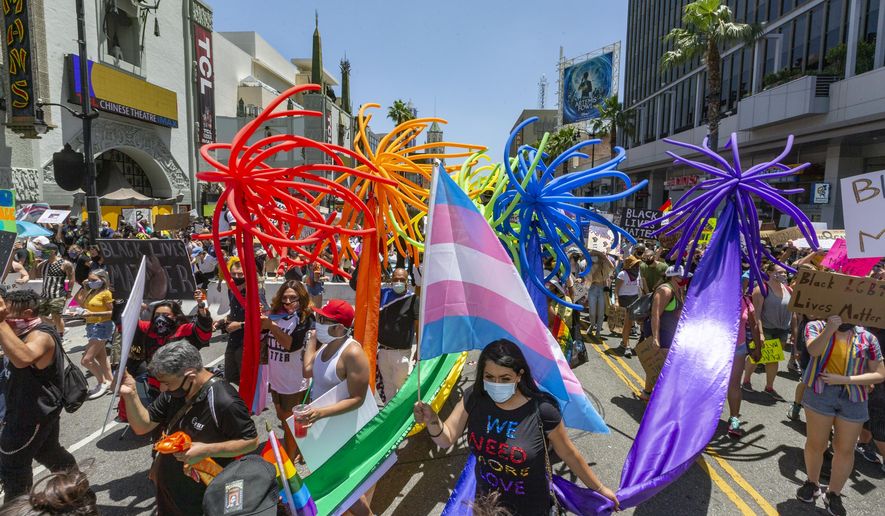 People gather in Hollywood for an "All Black Lives Matter" march, organized by black members of the LGBTQ+ community in the Hollywood section of Los Angeles Sunday, June 14, 2020. (AP Photo/Damian Dovarganes)
