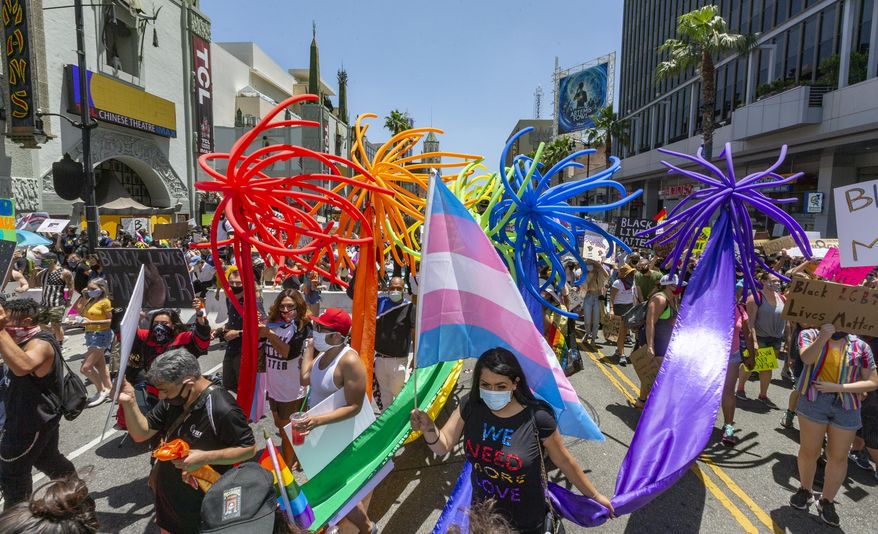 People gather in Hollywood for an "All Black Lives Matter" march, organized by black members of the LGBTQ+ community in the Hollywood section of Los Angeles Sunday, June 14, 2020. (AP Photo/Damian Dovarganes)