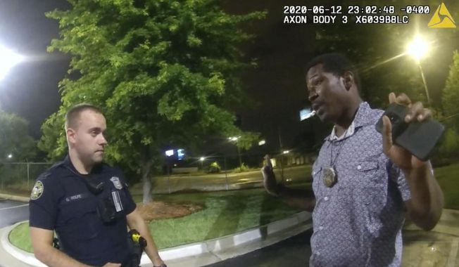 This screen grab taken from body camera video provided by the Atlanta Police Department shows Rayshard Brooks speaking with Officer Garrett Rolfe in the parking lot of a Wendy&#x27;s restaurant, late Friday, June 12, 2020, in Atlanta. Rolfe has been fired following the fatal shooting of Brooks and a second officer has been placed on administrative duty. (Atlanta Police Department via AP)
