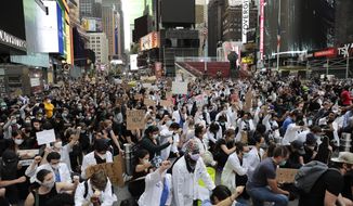 Protesters kneel in Times Square in New York, Tuesday, June 2, 2020. The New York City immortalized in song and scene has been swapped out for the last few months with the virus version. In all the unknowing of what the future holds, there&#39;s faith in that other quintessential facet of New York City: that the city will adapt. (AP Photo/Seth Wenig)