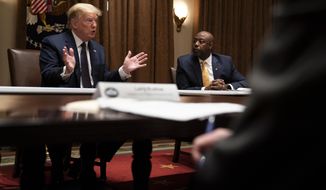 Sen. Tim Scott, R-S.C., right, listens as President Donald Trump speaks during a meeting on opportunity zones in the Cabinet Room of the White House, Monday, May 18, 2020, in Washington. (AP Photo/Evan Vucci)