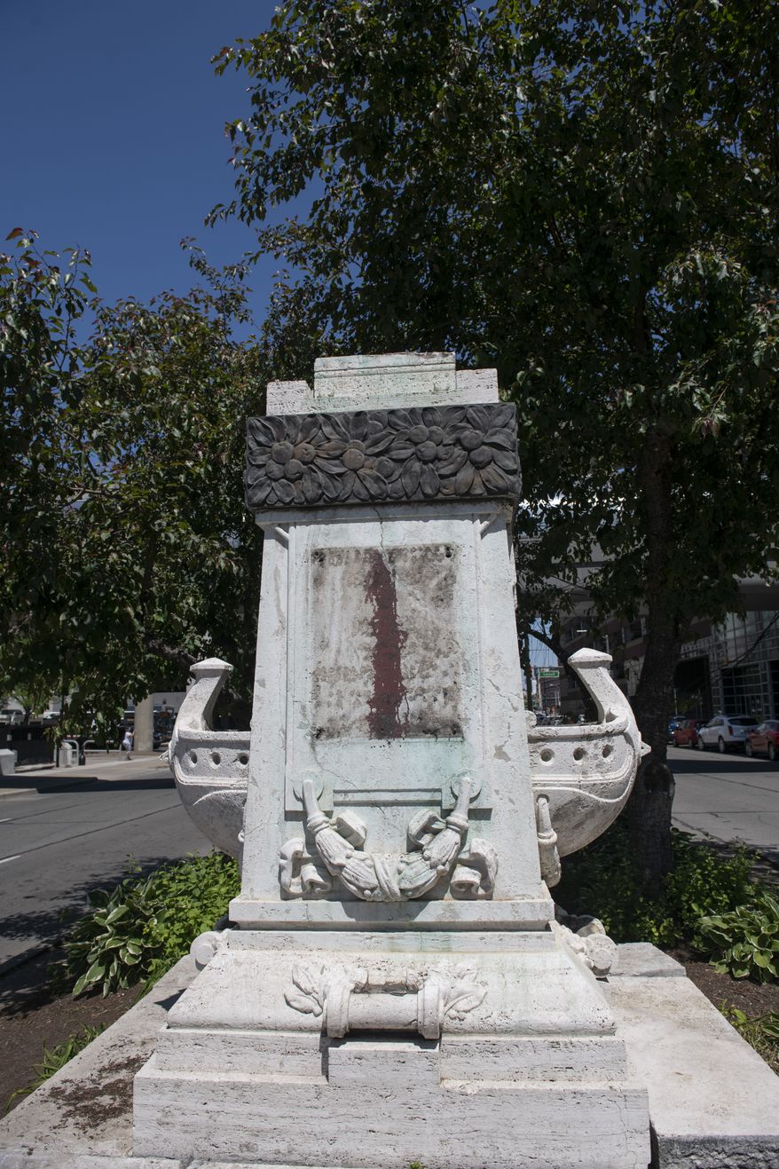 The City of Detroit removed the bust of Christopher Columbus statue in the median of Randolph Street facing the intersection of Jefferson Avenue in downtown Detroit. Workers removed the statue Monday morning, June 15, 2020. All that remains is the empty pedestal.  (John T. Greilick/Detroit News via AP)