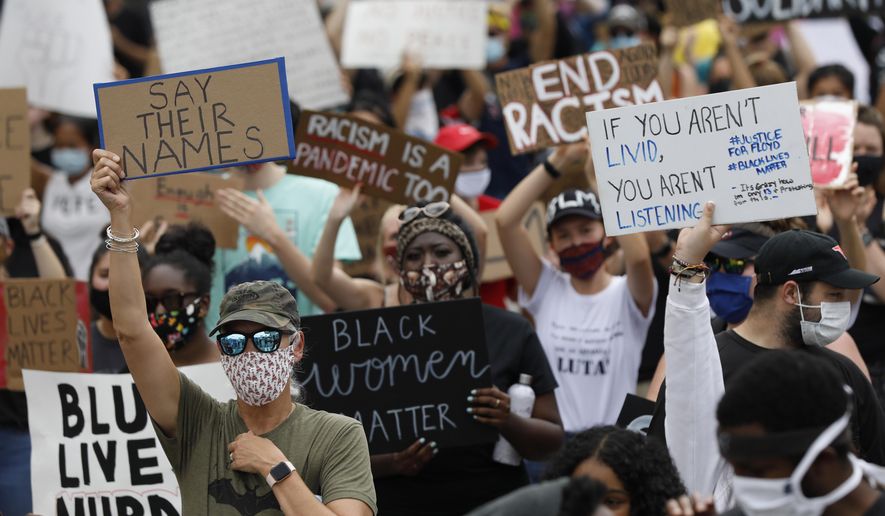 Protesters fill College Avenue during the Athens Anti Discrimination Movement 'Justice For Black Lives Rally' for the deaths of George Floyd, Breonna Taylor and Ahmaud Arbery in downtown Athens, Ga, on Saturday, June 6, 2020. (Joshua L. Jones/Athens Banner-Herald via AP)