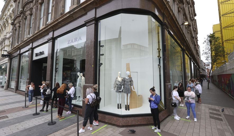 Shoppers queue outside Zara in Belfast, northern Ireland, Monday, June 15, 2020. After three months of being closed under coronavirus restrictions, shops selling fashion, toys and other non-essential goods are being allowed to reopen across England for the first time since the country went into lockdown in March. (Liam McBurney/PA via AP)