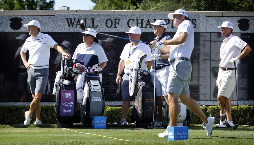 Jordan Spieth, left, watches Ryan Palmer tee off the first hole during practice for the Charles Schwab Challenge golf tournament at the Colonial Country Club in Fort Worth, Texas, Tuesday, June 9, 2020. The Challenge is the first PGA tour event since the COVID-19 pandemic began. (Tom Fox/The Dallas Morning News via AP)