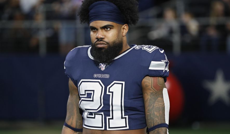 FILE - In this Dec. 15, 2019, file photo, Dallas Cowboys running back Ezekiel Elliott (21) warms up before an NFL football game against the Los Angeles Rams in Arlington, Texas. Ezekiel Elliott tested positive for the coronavirus, according to his agent. Rocky Arceneaux told the NFL Network on Monday, June 15, 2020, that Elliott was feeling OK and recovering.(AP Photo/Roger Steinman, FIle)